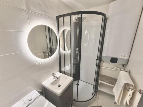 a bathroom with a shower and a sink and a mirror at 2 Bedrooms, TV & Wifi in Villers-sur-Mer