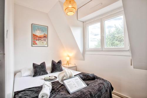 a bedroom with a bed with a laptop on it at 2 Bedrooms, TV & Wifi in Villers-sur-Mer