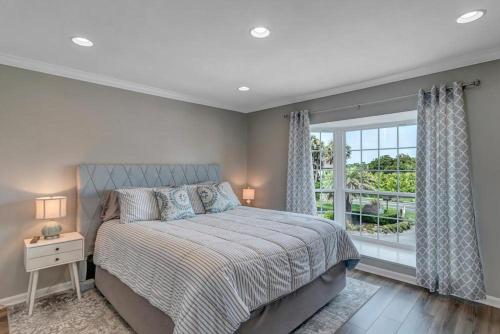 a bedroom with a large bed and a window at Wellness Retreat - Oceanfront condo w beach access in Ponte Vedra Beach