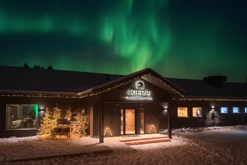 a ski lodge with the aurora in the sky at Wilderness Hotel Kieppi in Saariselka