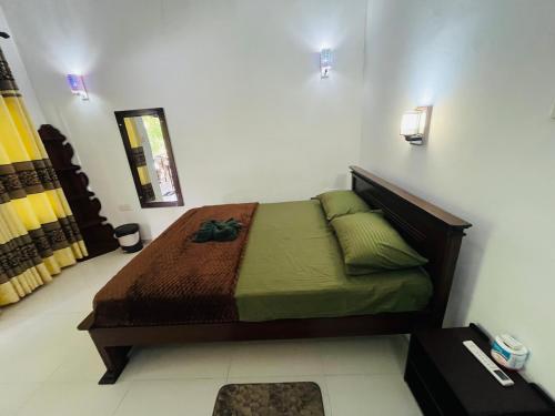 a bedroom with a bed in a room at Eco Villa - Sinharaja in Deniyaya