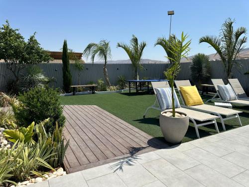 een patio met stoelen en een tafel in de tuin bij צמרת נופש in Rewaya