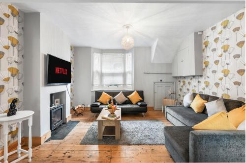 a living room with a couch and a table at The Quirk & Timber Retreat with Free parking in Brighton & Hove