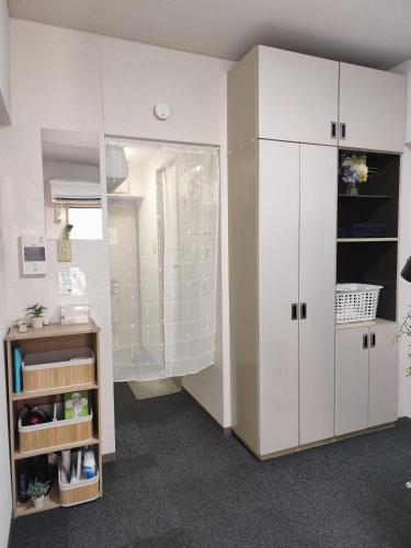 a room with a large white cabinet and a shelf at JKhouse5 in Fukuoka