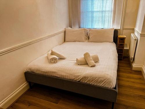 łóżko z dwiema poduszkami w pokoju w obiekcie Coastal 3-Bed Flat near Lowestoft Beach w mieście Lowestoft