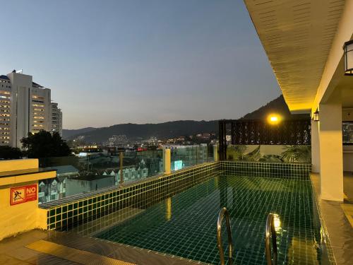 a swimming pool on the roof of a building at Priew Wan Guesthouse in Patong Beach