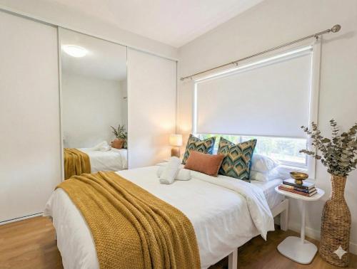 a bedroom with a bed and a large mirror at Huge 3Bed House and Backyard & 4 Car Park spaces and Near Parramatta in Wentworthville