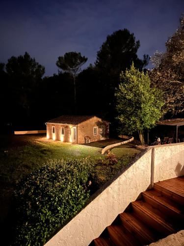 a house with lights in a yard at night at La maison des Oiseaux in Trans-en-Provence