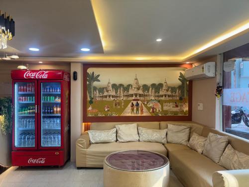 un soggiorno con un frigorifero Coca Cola e un divano di Hotel AYODHYA HERITAGE a Ayodhya