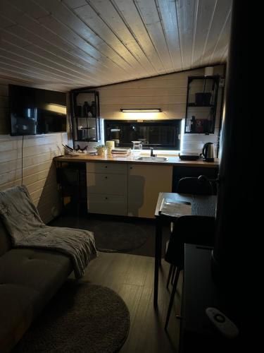a small kitchen with a couch and a table at Santa Elves Cabin in Rovaniemi