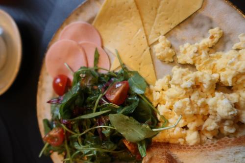 a plate of food with a salad and vegetables at Gloria Hotel by YOLO in Szack