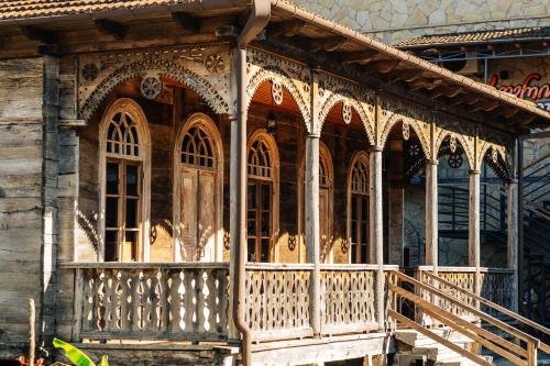 an old building with a wooden porch and a balcony at Kera Ethno Hotel in Gvishtibi