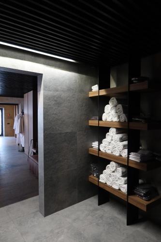 a room with a wall with shelves with towels at Gloria Hotel in Szack