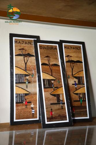 Tres fotografías enmarcadas de un parque con sombrillas. en Majik Resort Beach, en Busia