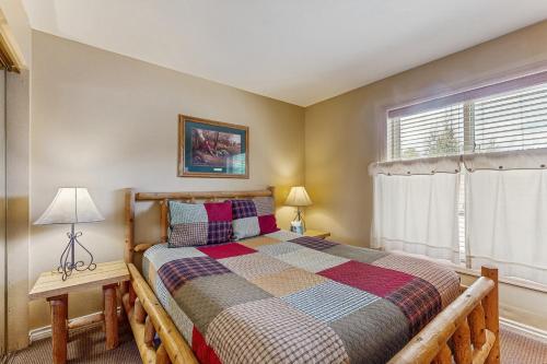 a bedroom with a bed and a window at On the Rapids - A Unit in Grand Lake