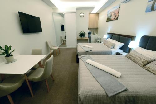 a hotel room with two beds and a table at Harbour Retreat in Hayborough