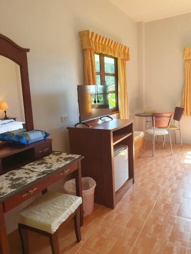 a living room with a desk and a mirror at Groovy Bungalows in Ao Nang Beach