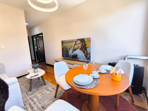 une salle à manger avec une table en bois et des chaises blanches dans l'établissement SafeHouse, à La Paz
