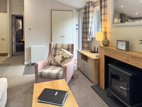 un soggiorno con sedia e camino di Portland a Holton Heath