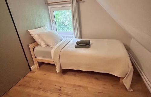 a small bed in a room with a window at Bosvilla Berk met een Jacuzzi in Geesbrug