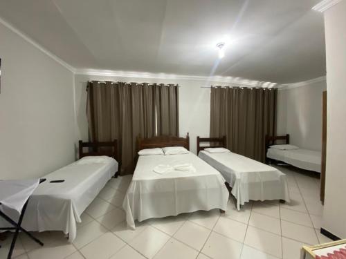 Ένα ή περισσότερα κρεβάτια σε δωμάτιο στο Hotel Minas Brasil