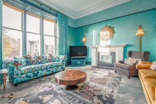 a living room with a couch and a fireplace at 12A Queens Gardens, St Andrews in St. Andrews