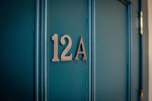 a blue door with the number on it at 12A Queens Gardens, St Andrews in St. Andrews
