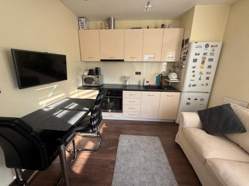 a small kitchen with a table and a couch at Pasarel House in Pasarel