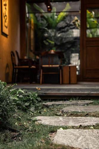 an entrance to a building with a door and a plant at Chaozhou Wuta Tanju Designer Courtyard Retreat - Inside Ancient City, Near Paifang Street, Guangji Bridge & Kaiyuan Temple - Kung Fu Tea & Coffee - Pet Friendly, Pick-up Service & Free Breakfast in Chaozhou