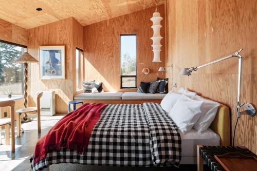 a bedroom with a bed in a room with wooden walls at Wild Meadow in Sea Ranch