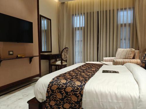 a hotel room with a bed and a television at The Himalayan Residency in Duttnager