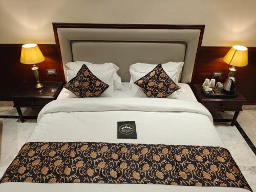 a bedroom with a large bed with two night stands at The Himalayan Residency in Duttnager