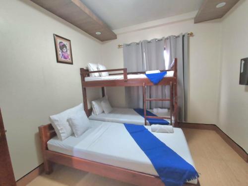 a bedroom with two bunk beds in a room at Monte casa de Rico in Vigan