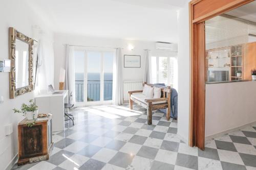 a living room with a checkered floor at Polanesi Sea View - Garden - AC - Free Park - Super Wi Fi in Sori