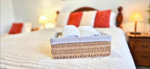 Una cama con toallas en una cesta encima. en Knossos Skynest, en Palaikastro