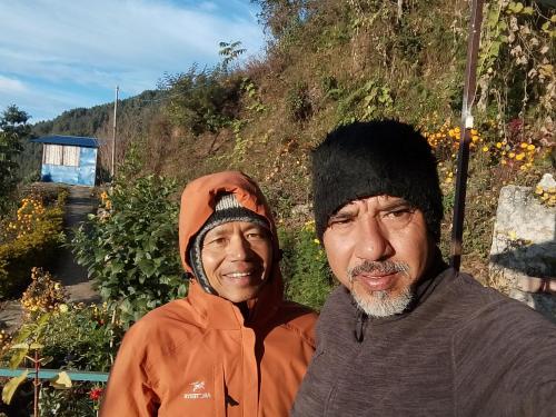 two men standing next to each other on a hill at Gaurishankar organic home stay in Dhulikhel