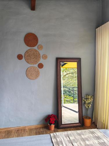 a mirror on a wall next to a bedroom at Hospedandote Emuná Chicamocha in Los Santos