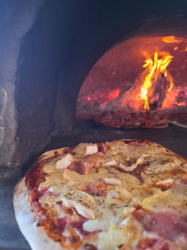 Studio de la Villa Thérèse, Piscine & Jardin في سان لوران دو فار: البيتزا أمام فرن النار