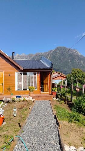 a home with a pathway leading to a house at Apartamento Puerta A La Patagonia 2 in Chaitén