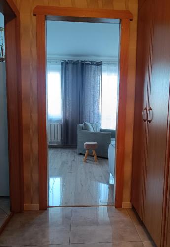 an open door to a living room with a couch at Przytulny Kąt in Żory