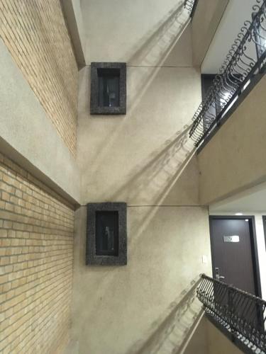 a staircase in a building with two windows at Chi Shing Hai Hotel in Dahan