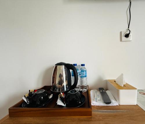 a tea kettle sitting on top of a wooden table at Talvista Kintamani Villa in Kintamani
