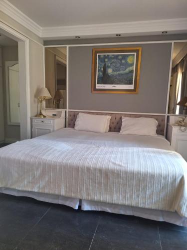 a bedroom with a large bed with a white comforter at Landmark jardins cobertura in São Paulo