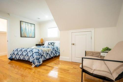 a bedroom with a bed and a chair at 80-3 3BR Boston - Cozy Apt near Dorchester Center in Boston