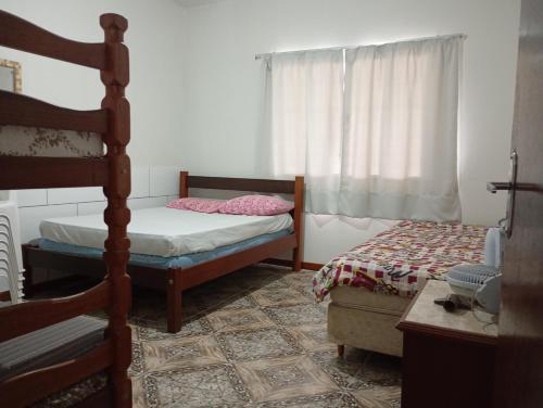 Ένα ή περισσότερα κρεβάτια σε δωμάτιο στο Casa da Márcia