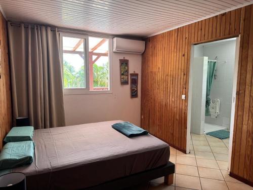 Ένα ή περισσότερα κρεβάτια σε δωμάτιο στο Le Petit Morne