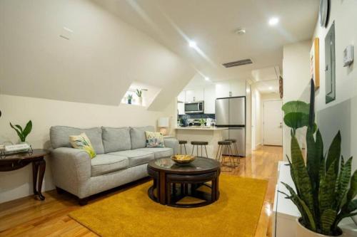 a living room with a couch and a table at 80-3 3BR Boston - Cozy Apt near Dorchester Center in Boston
