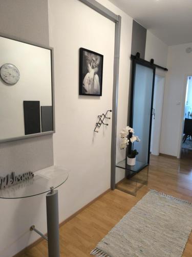a living room with a glass table and a mirror at 4 You Apartment in Leoben mit Balkon, Garten und kostenlosen Parkplatz in Leoben