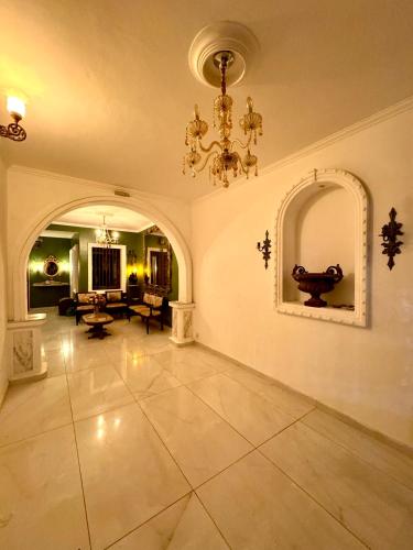 a large room with a chandelier and a living room at Casa da Josi - Pajuçara in Maceió
