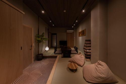 a living room with two beds and a table at New Open 一棟貸切宿KIKUNOYA-sora- in Nagoya